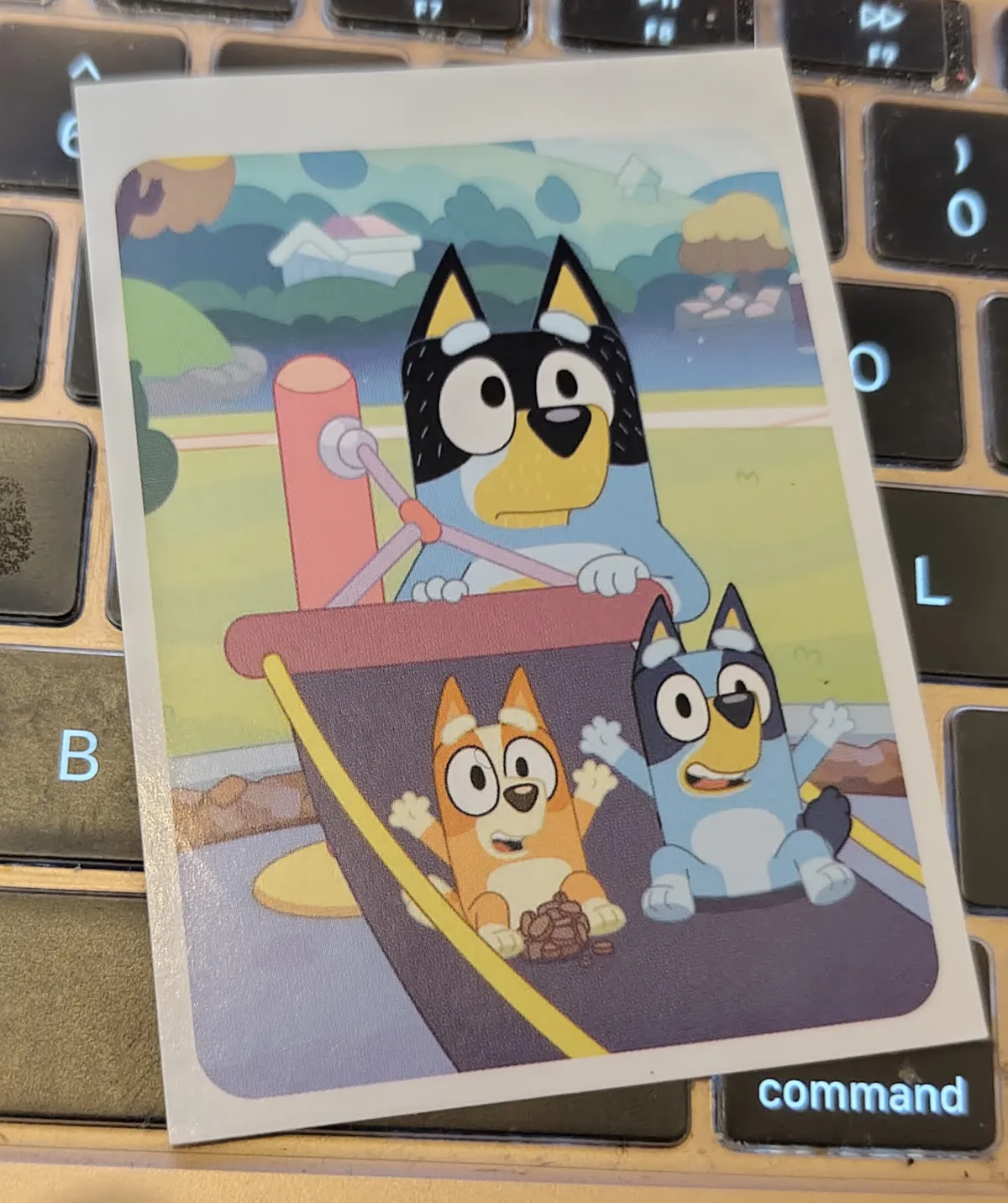 Bluey and Bingo are sitting on a hammock, excited to be in what appears to be the middle of a swing from Bandit, who is staring off into the distance, looking like he's having a midlife crisis over his place in the world. Who is he? What does the future hold? Has he really done everything he can do in his life?