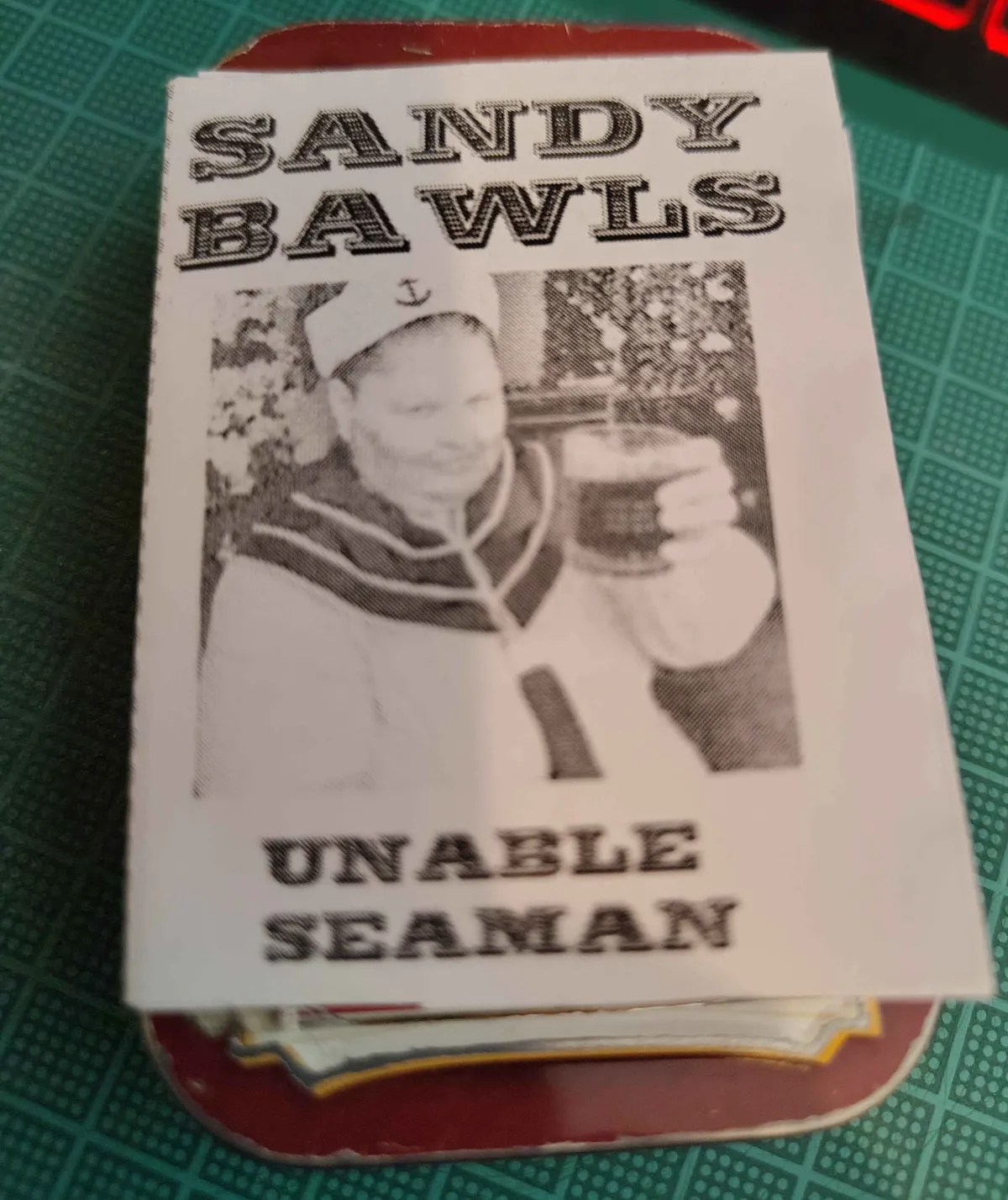 My tiny Sandy Bawls zine, sitting on top of an Altoids tin.