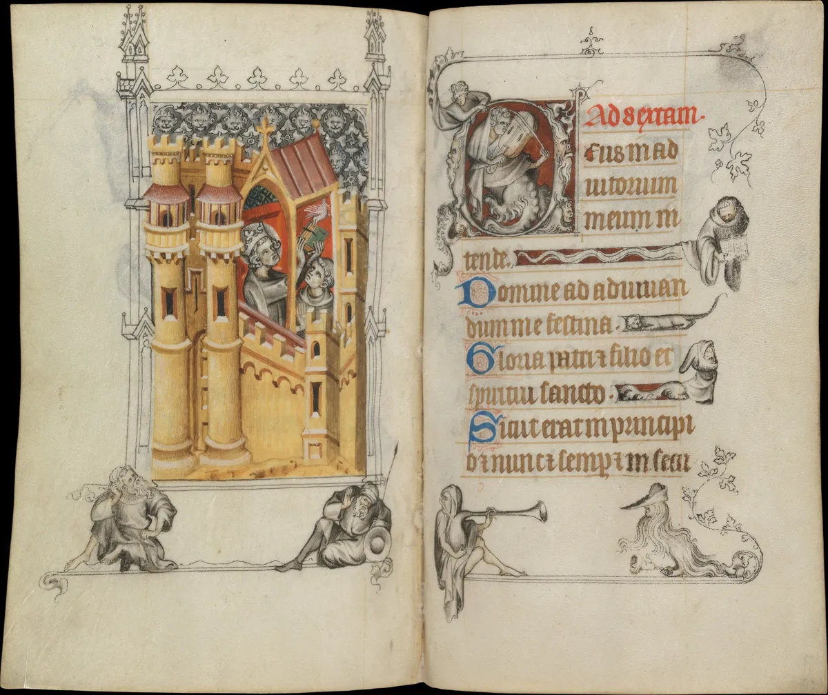 Two strange figures sitting beneath an architectural scene in the Hours of Jeanne d'Évreux