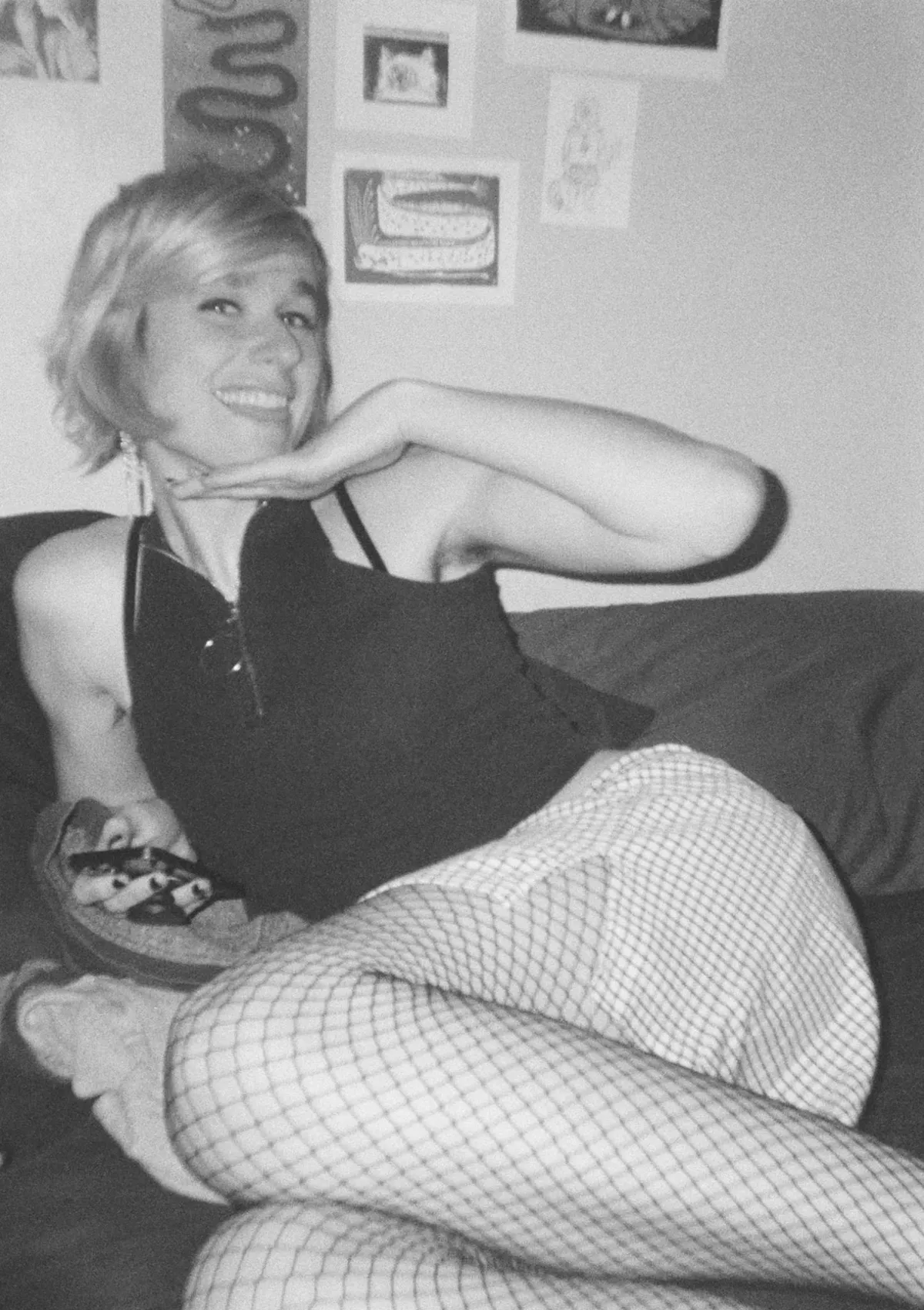 Picture of Noé in a cute little outfit smiling and posing for the camera and sticking her tongue out a little