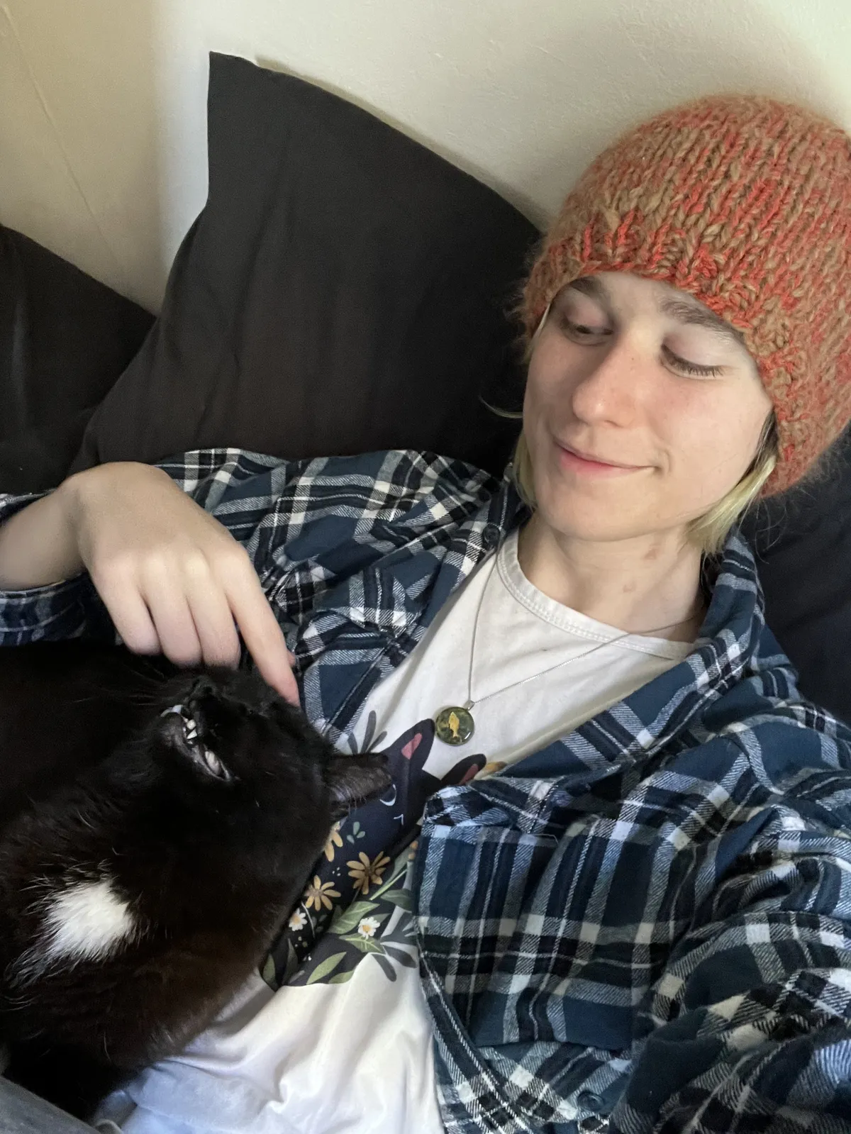 Pumpkin snuggling against me tilting his head back in bliss while I scratch his forehead.