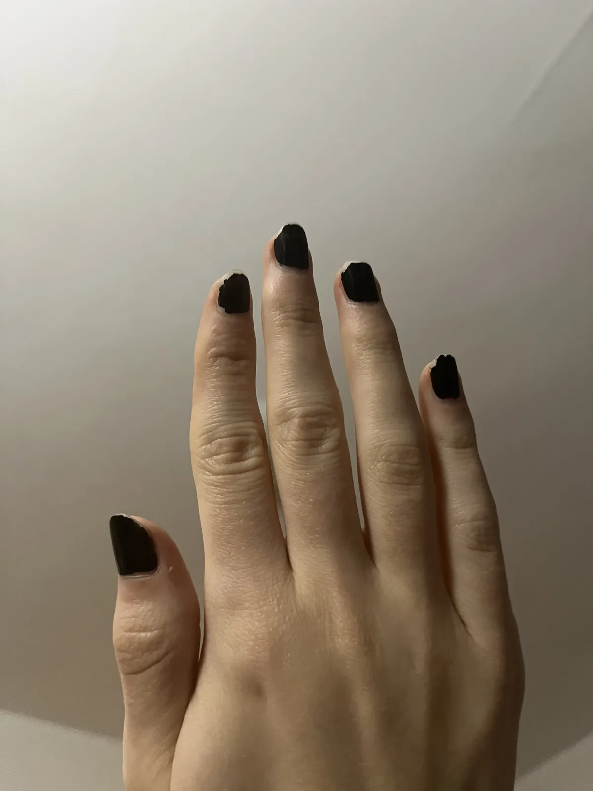The back of Noé's hand, showing her nails which haven't been bitten short!