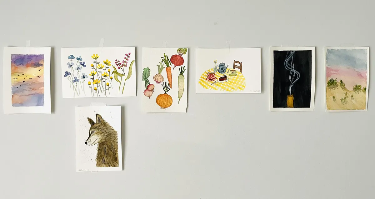 A wall of watercolour paintings
