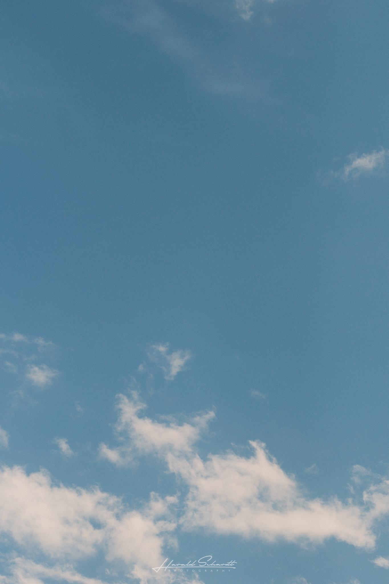Blue sky with a few small clouds