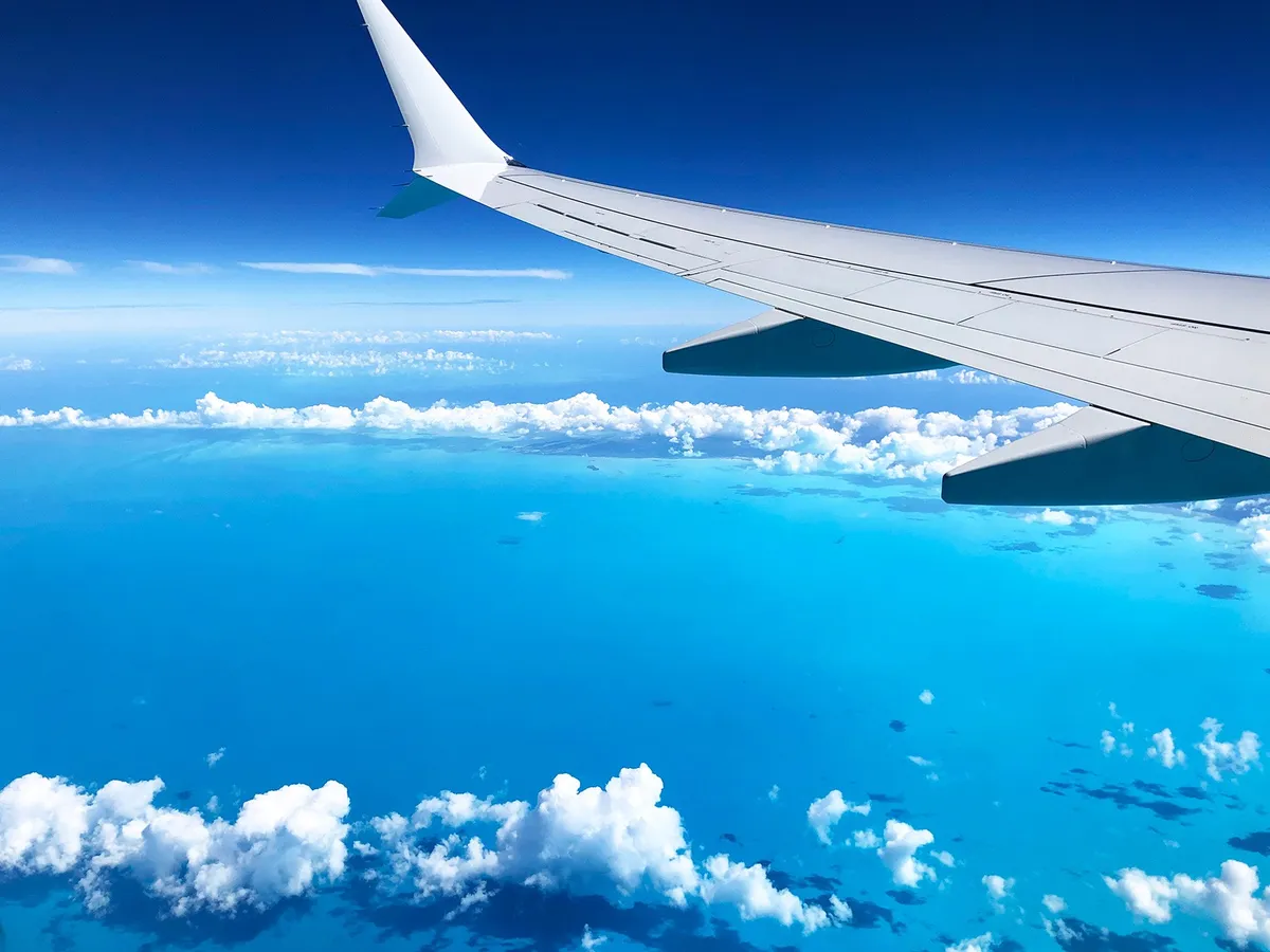 Airplane wing against a blue sky