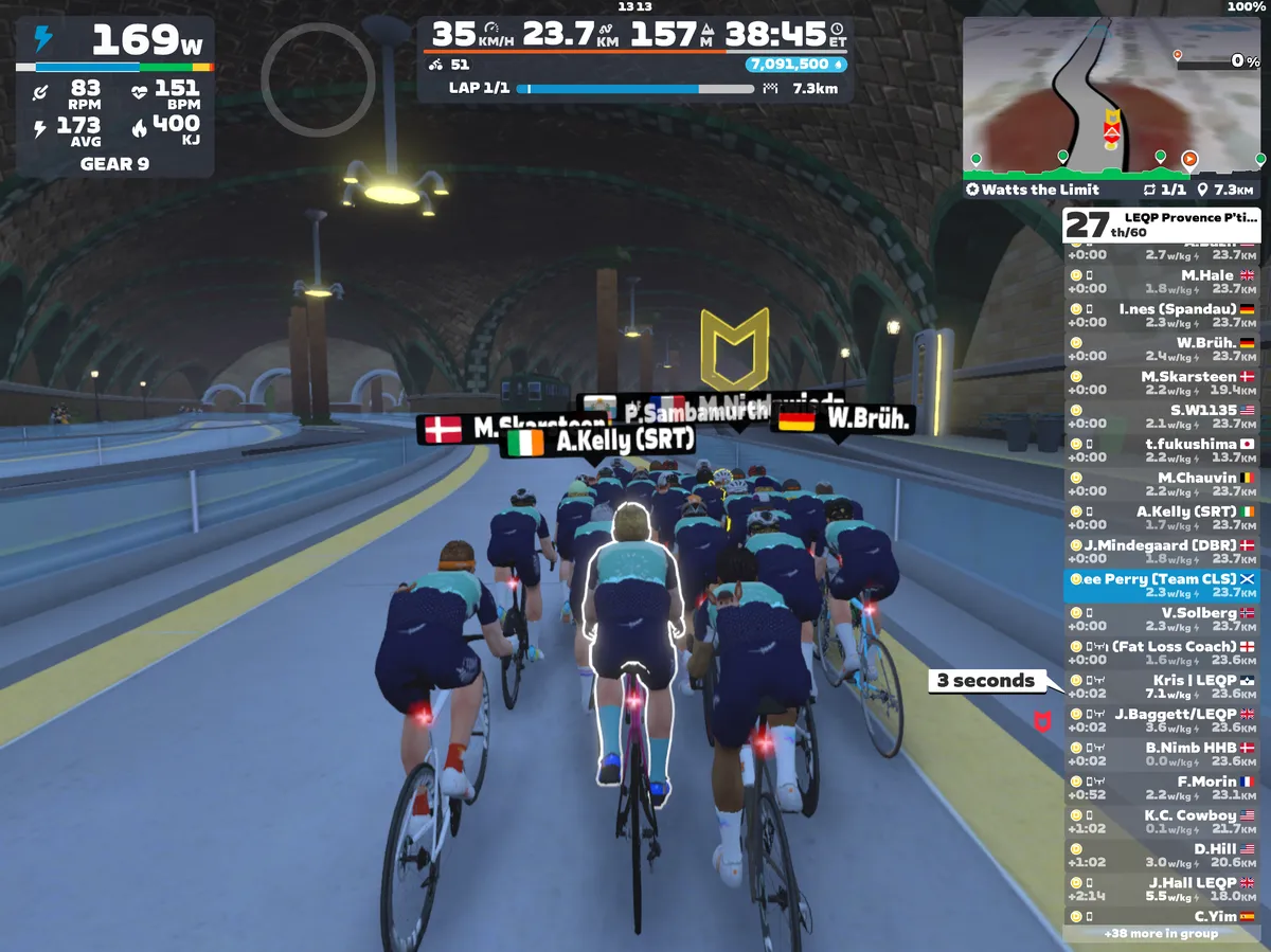 Screenshot from Zwift showing riders' avatars riding through railway tunnels