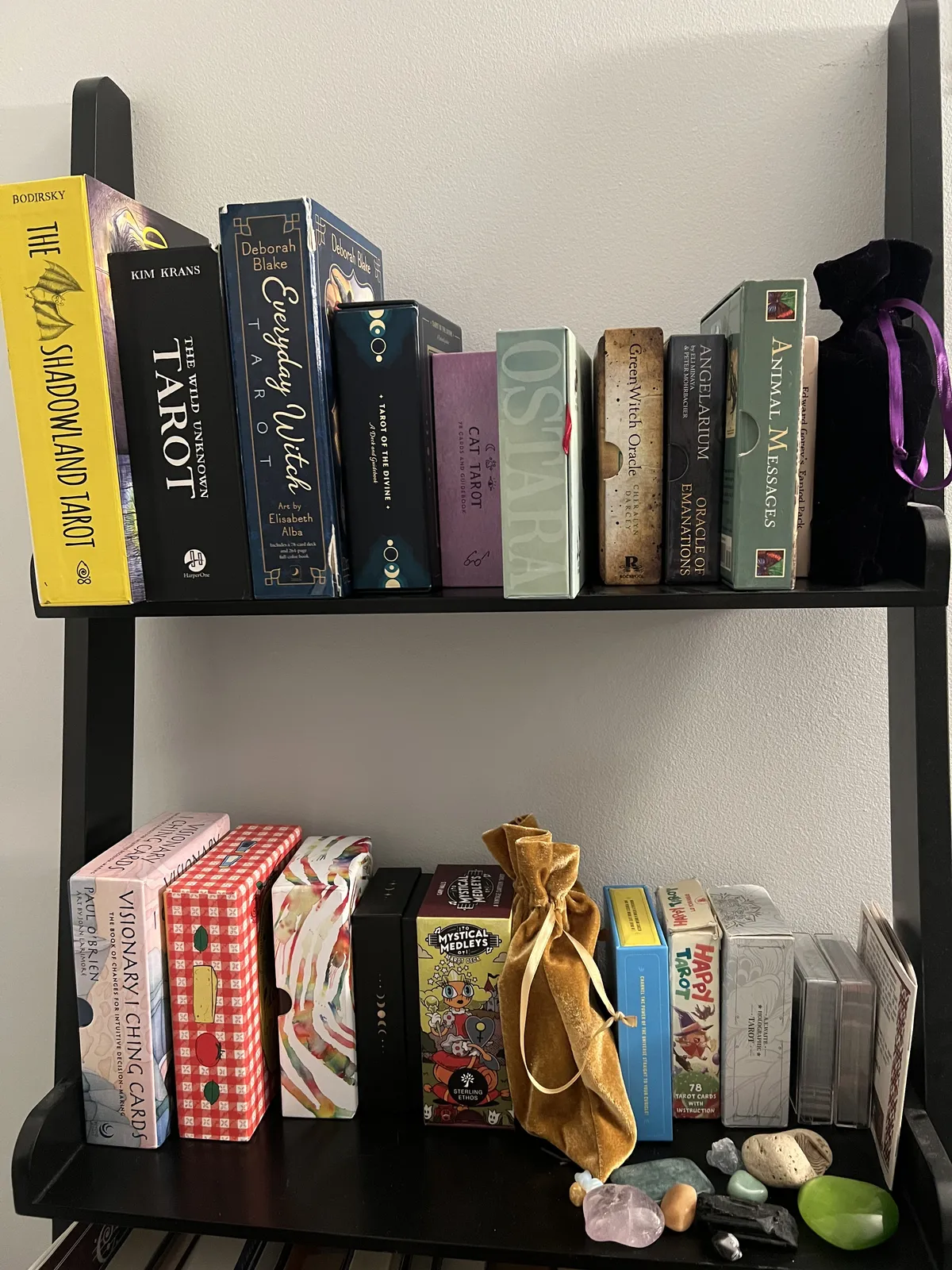 a bookshelf full of tarot decks