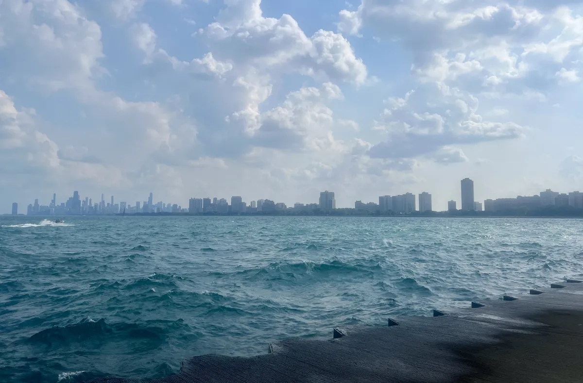 view of lake michigan from montrose harbor, with the downtown skyline visible in the distance