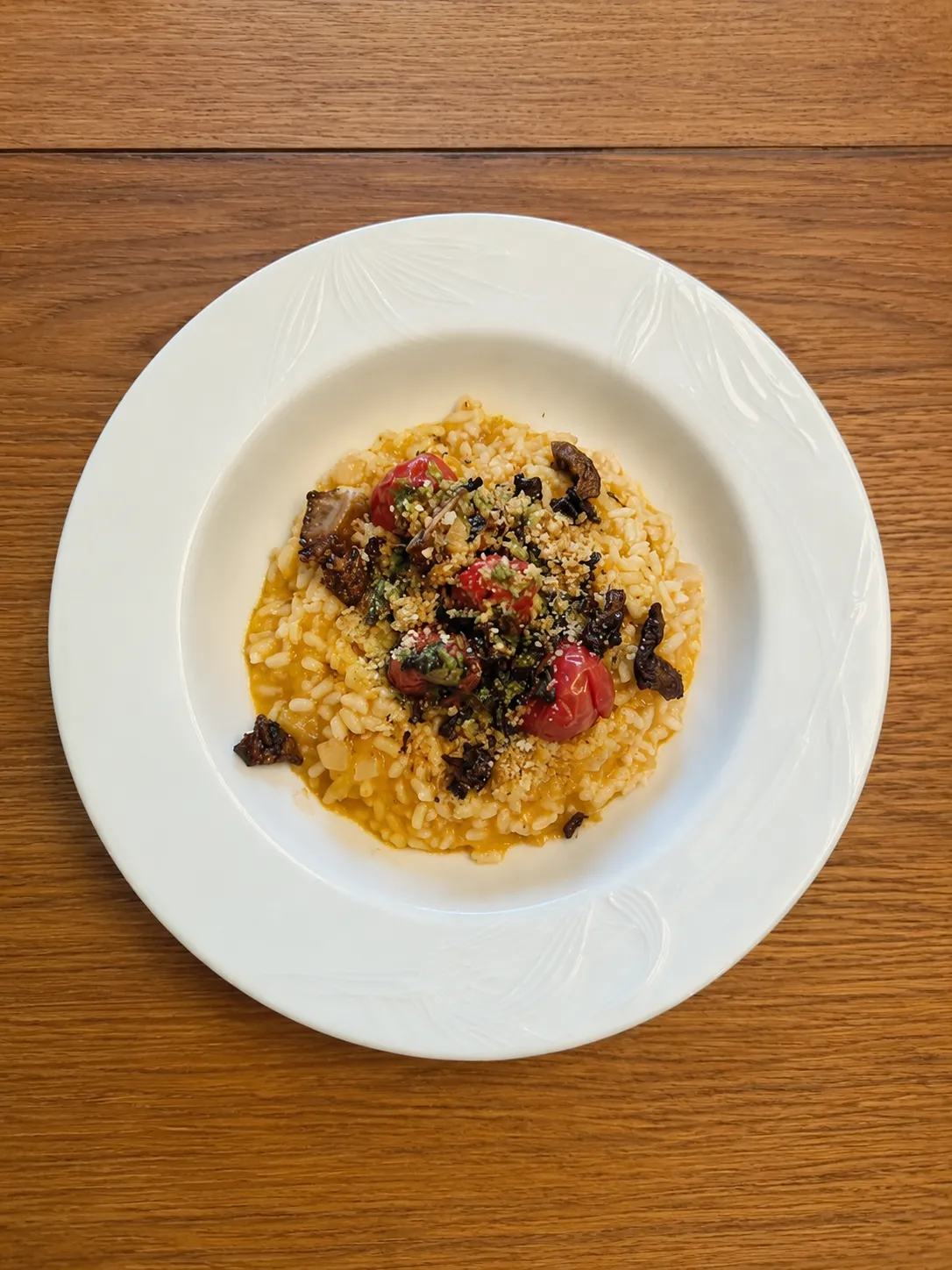 Smoked tomato risotto with roasted cherry tomatoes, crispy mushrooms, basil oil, and lemon pangrattato
