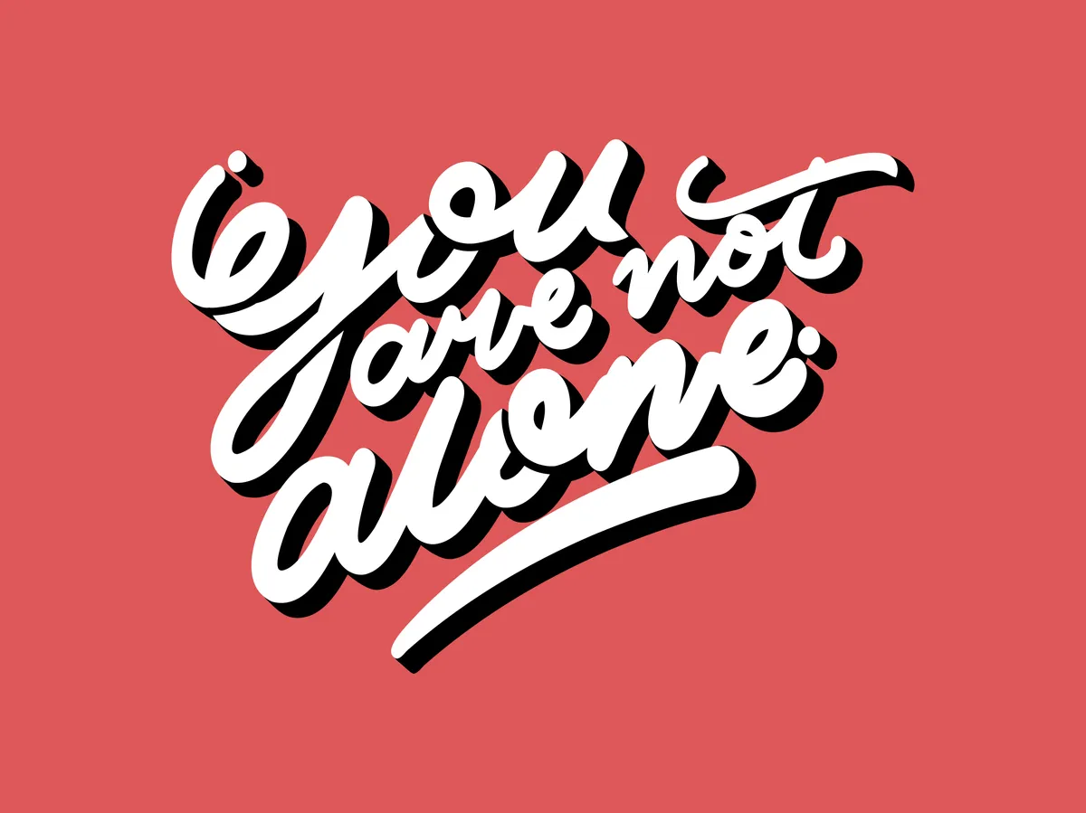 White script lettering on a red background with the words you are not alone