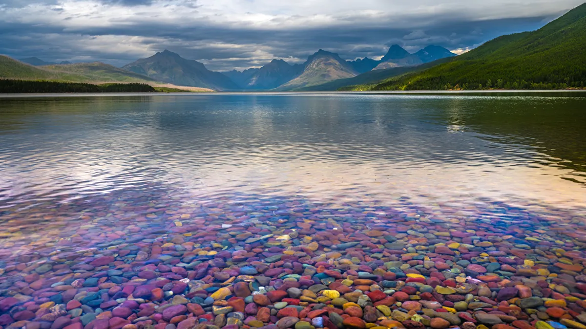 beautiful_greenery_mountain_calm_body_of_water_colorful_pebbles_hd_nature
