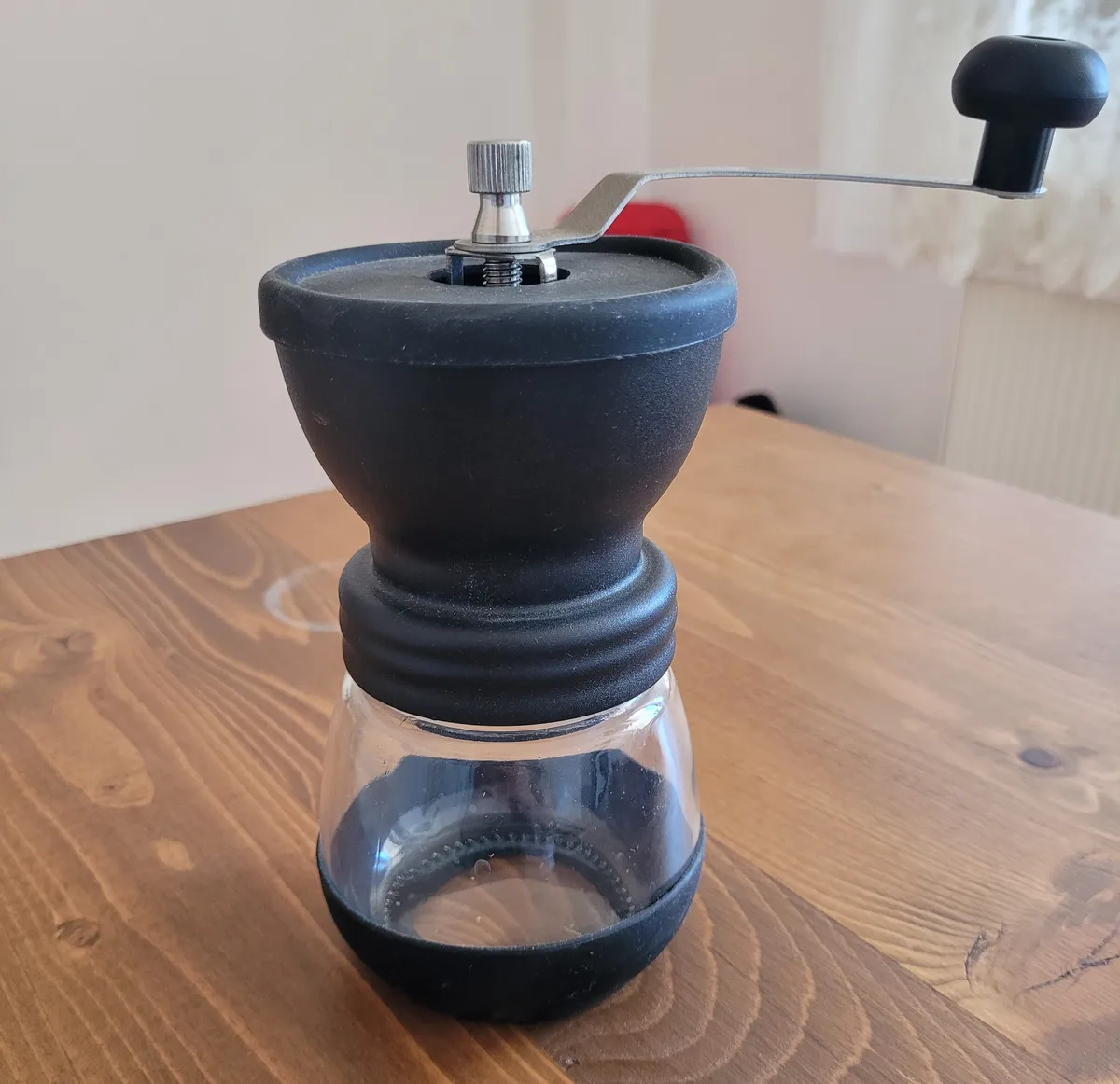 image of a coffee hand grinder on a wooden table