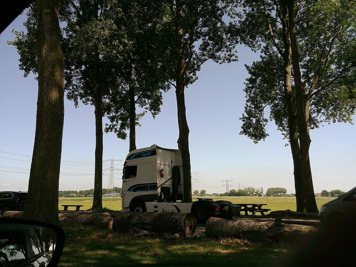 a truck without a trailer, parked at a gas station