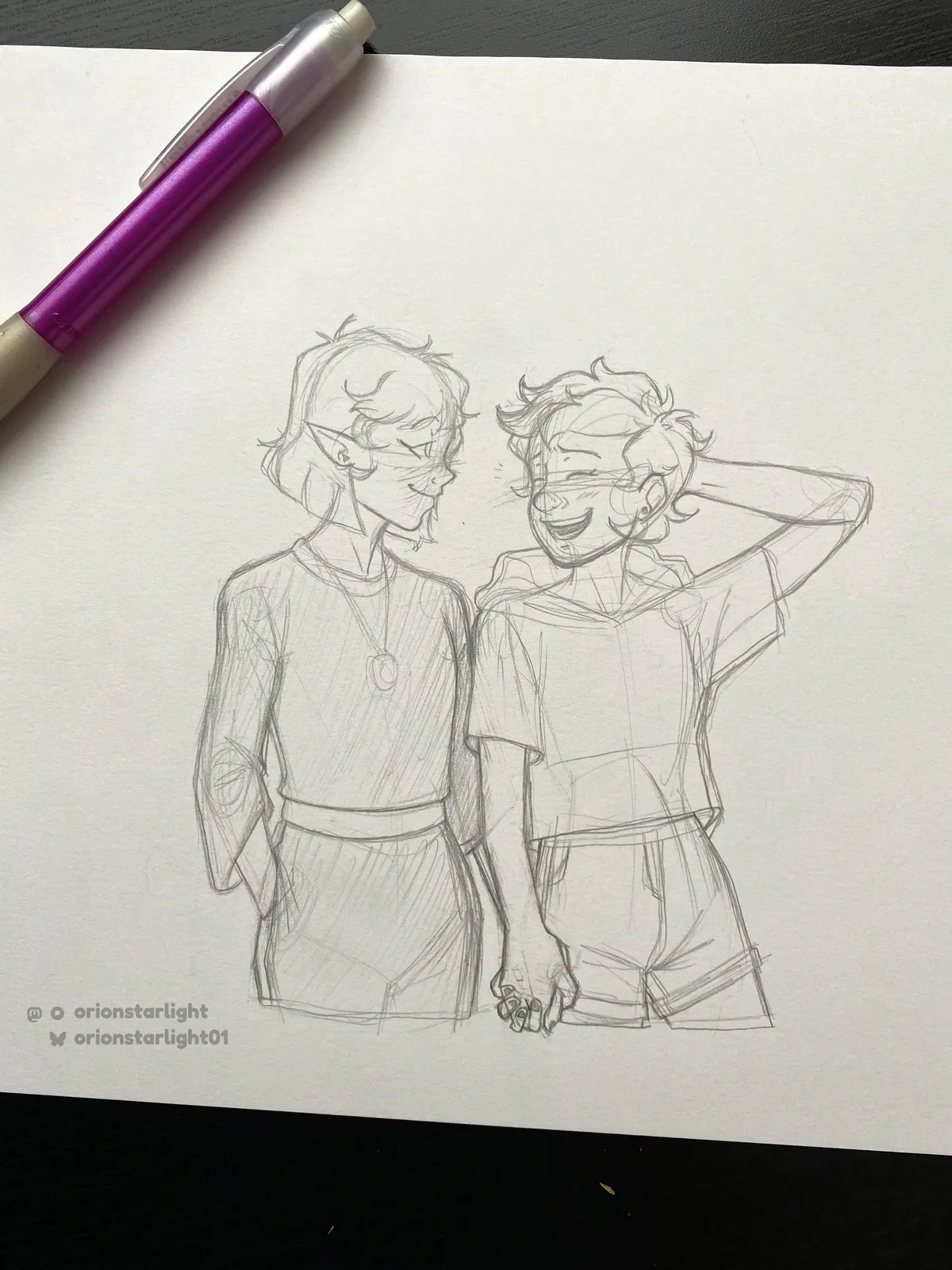 My pencil drawing of Luz Noceda and Amity Blight holding hands. Luz is drawn in her season 1 casual outfit while Amity is in her 2nd main outfit with her short purple hair.