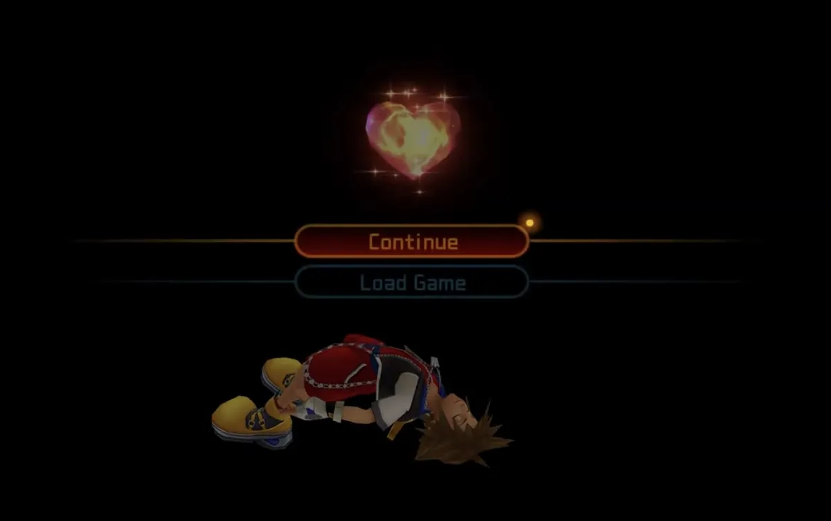 A screenshot from the game, Kingdom Hearts 1. The main protagonist, Sora, is floating in the darkness with his illuminated heart gently floating above him. Sora’s eyes are closed and he has a calm expression. Two select buttons are in the middle of the screen with one titled ‘Continue?’ and the one below it titled ‘Load Game’.