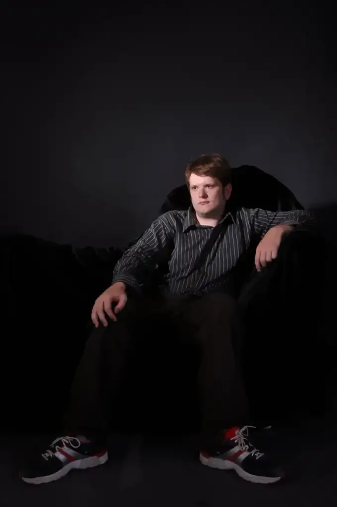 oz sitting on a chair, looking off camera