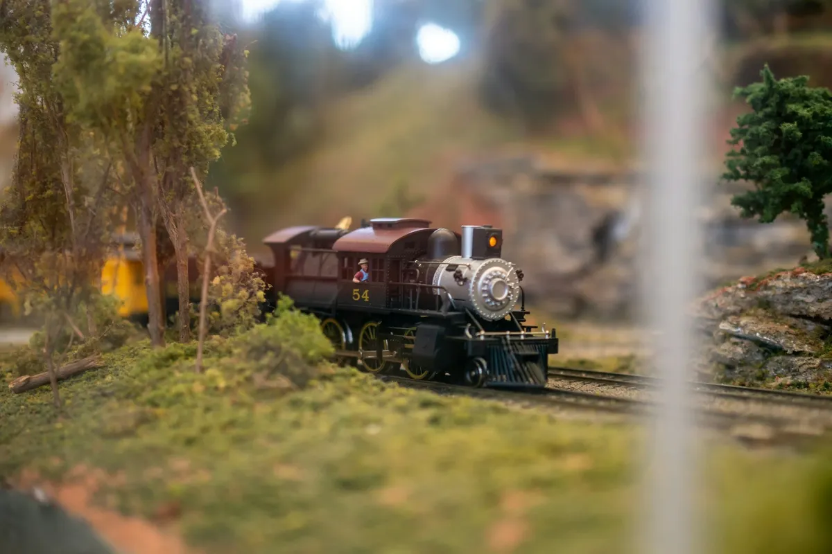 A model train with a tiny little conductor