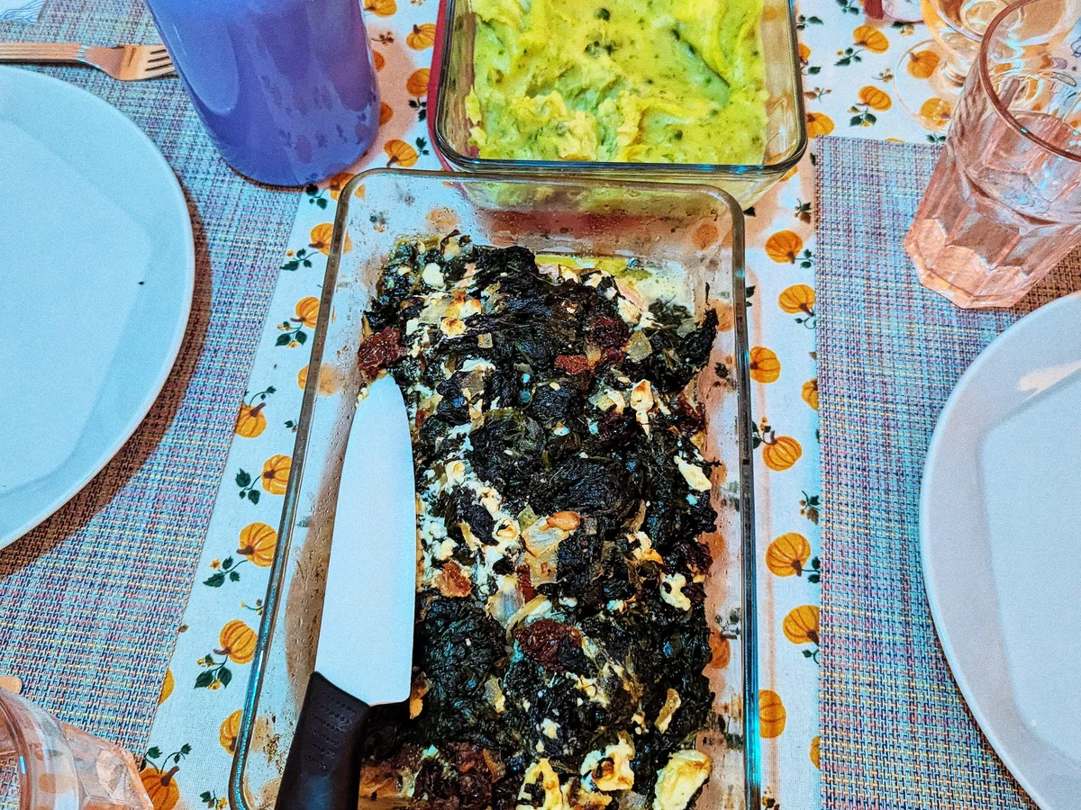 Closeup of the baked salmon dish. Visibly it's mostly just spinach and feta.