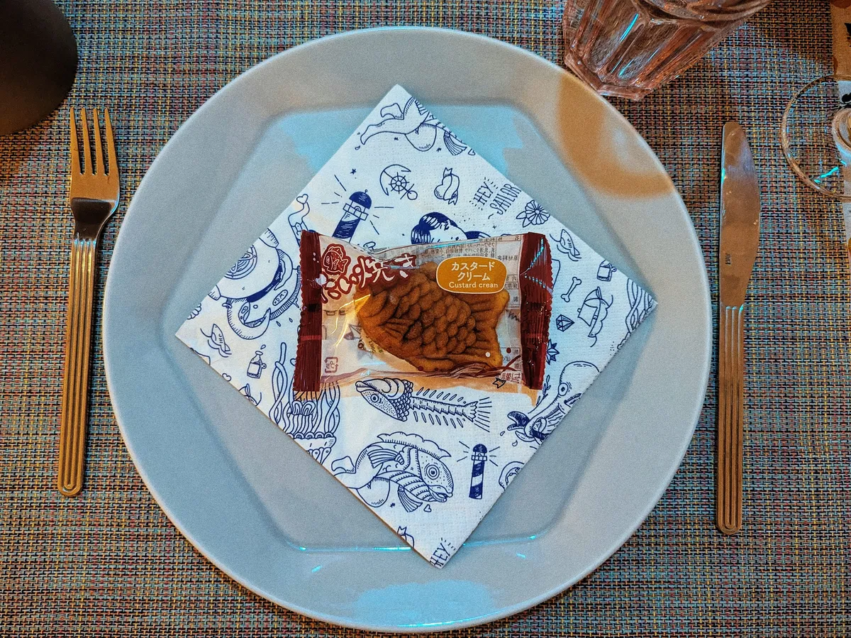 A packaged taiyaki is laid on top of a sailor-themed napkin.