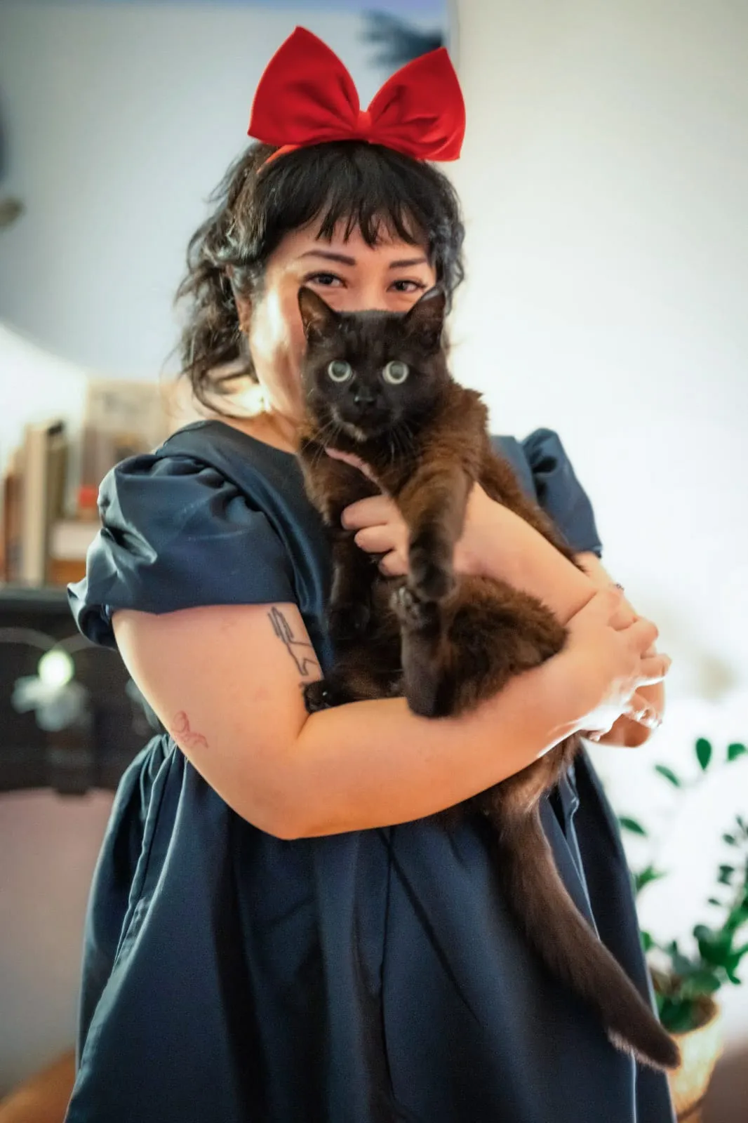 Peige holding Boba. They are both staring straight at the camera, though Boba looks scared.