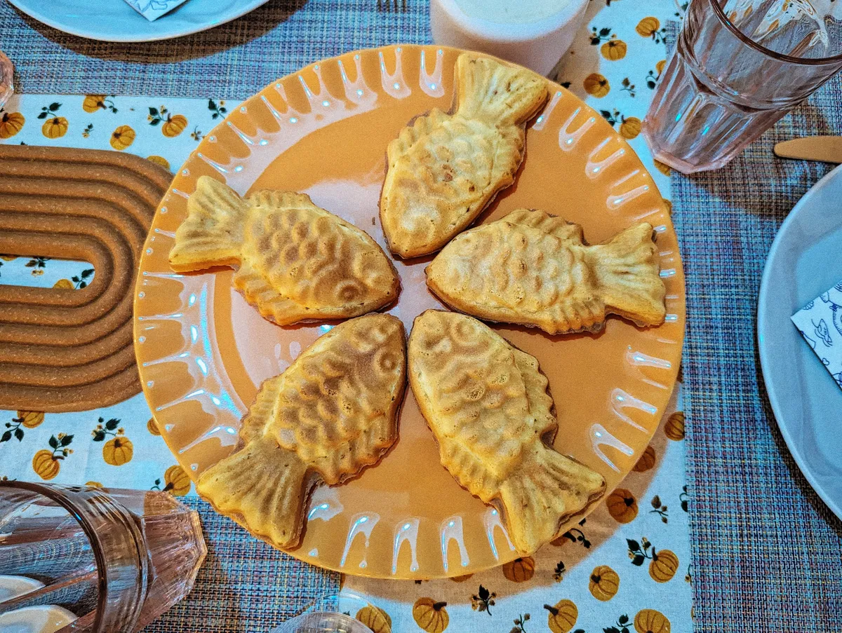 Fish-shaped pastries arranged in a star shape, with the fishes' mouths touching each other.