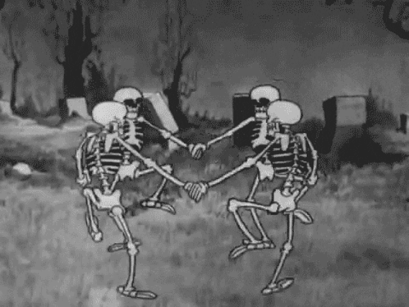 Skeletons holding hands and dancing around in a circle.