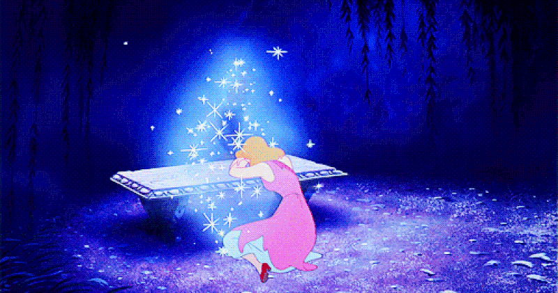 Cinderella weeping into her fairy godmother's lap.