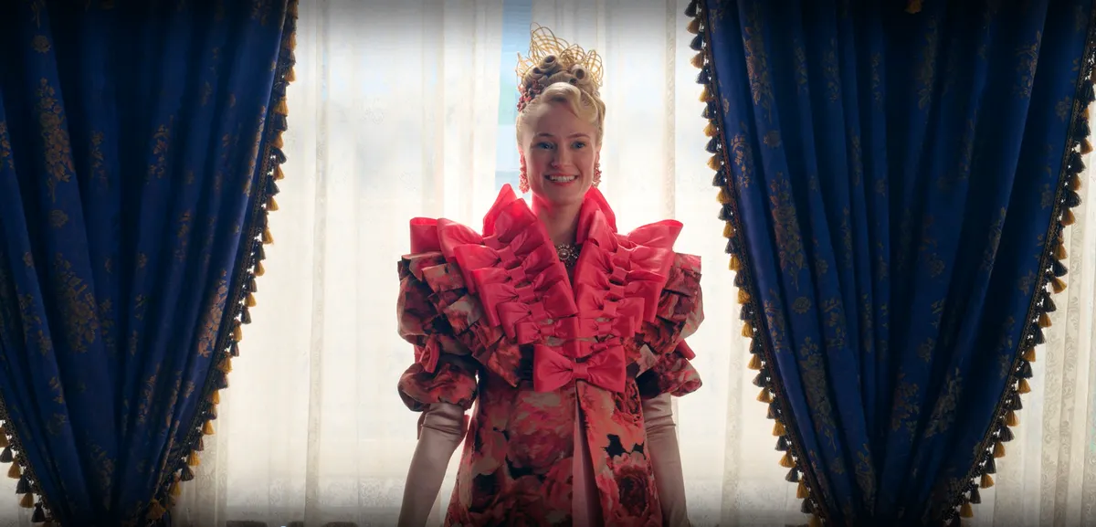 Cressida Pendelwood wearing a dress lined with giant pink bows along the collar.