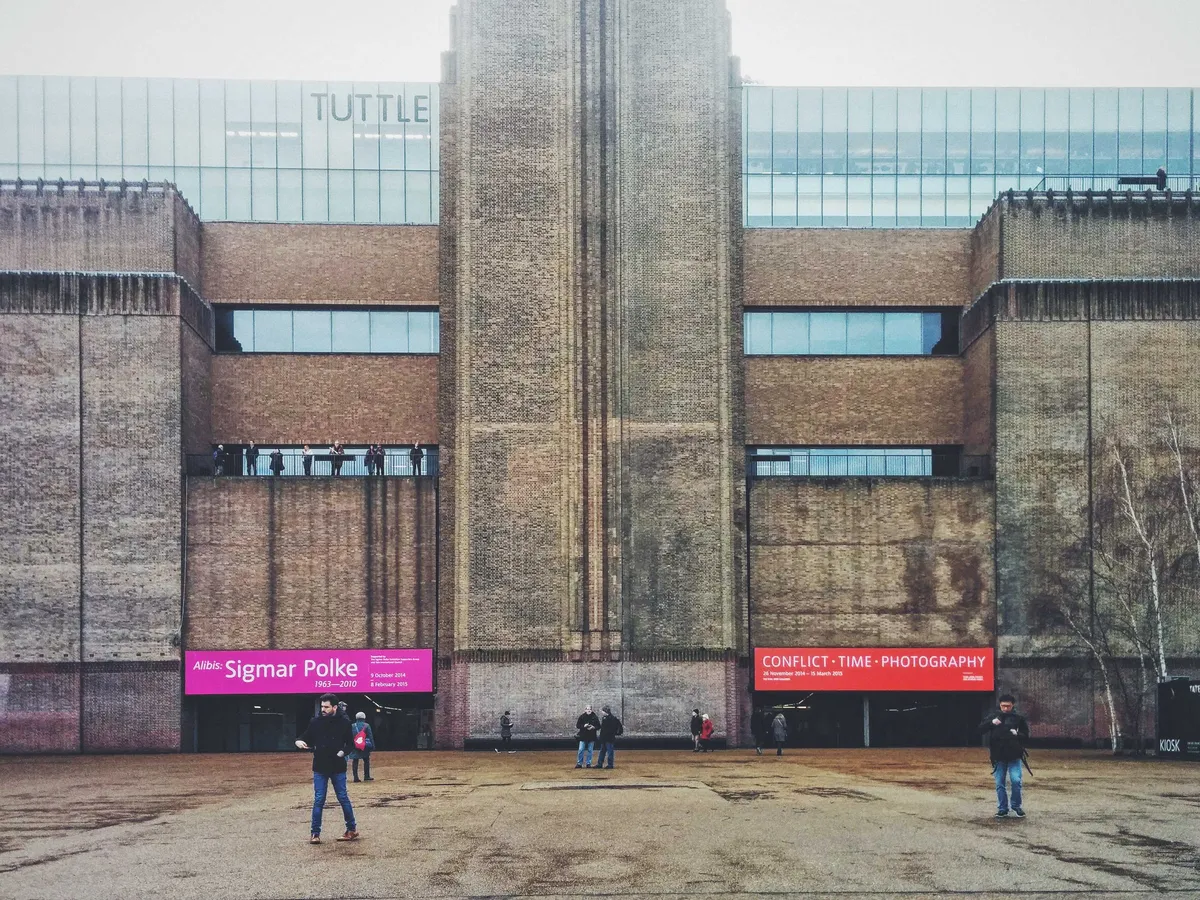 The front of the Tate Modern, a brutalist style building made of bricks.