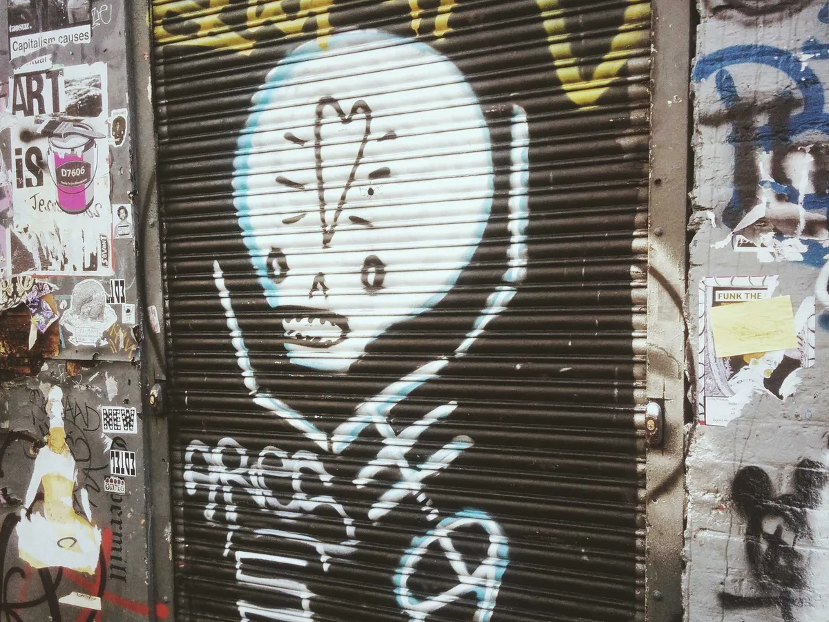 Graffiti art of a cute skeleton with a heart on its forehead.
