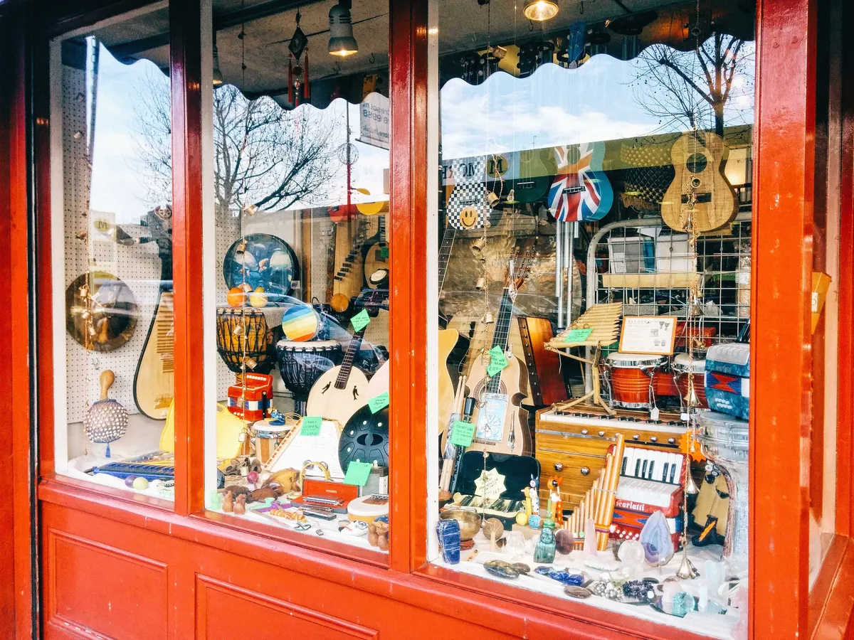 The shopfront window of Ray Man, filled with eclectic instruments.