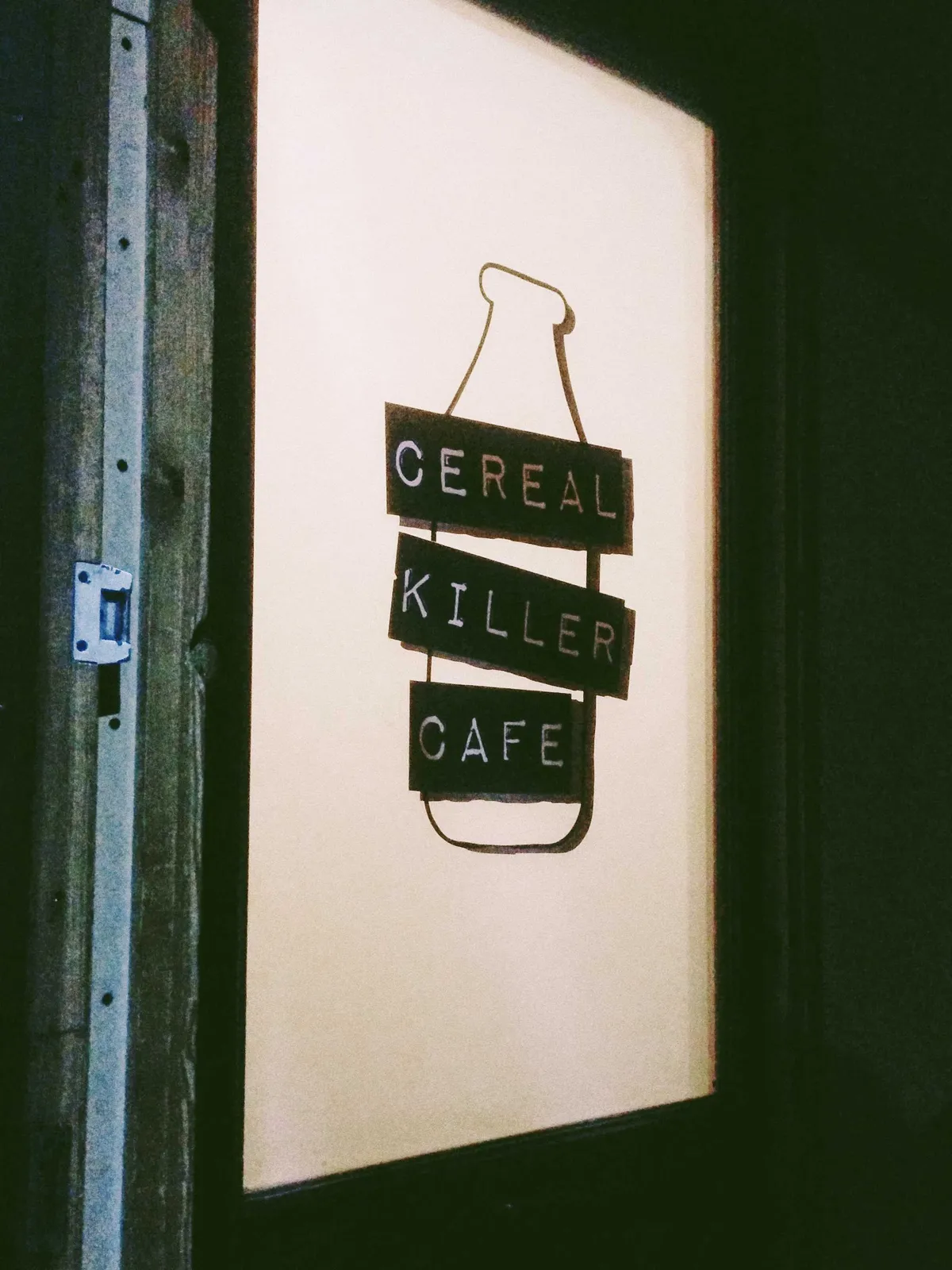 A frosted glass door with a giant logo of 