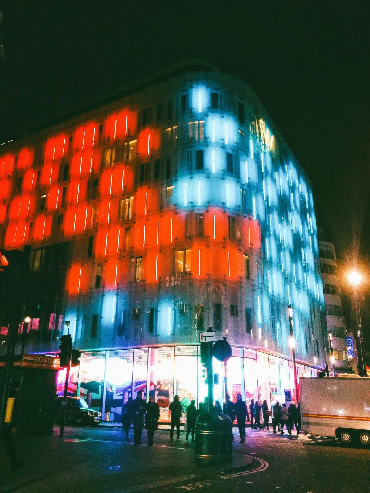 A building with neon lights stylishly lit across the facade.