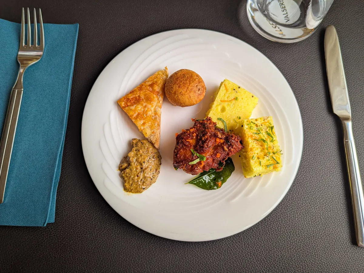A colorful plate of various small bites.