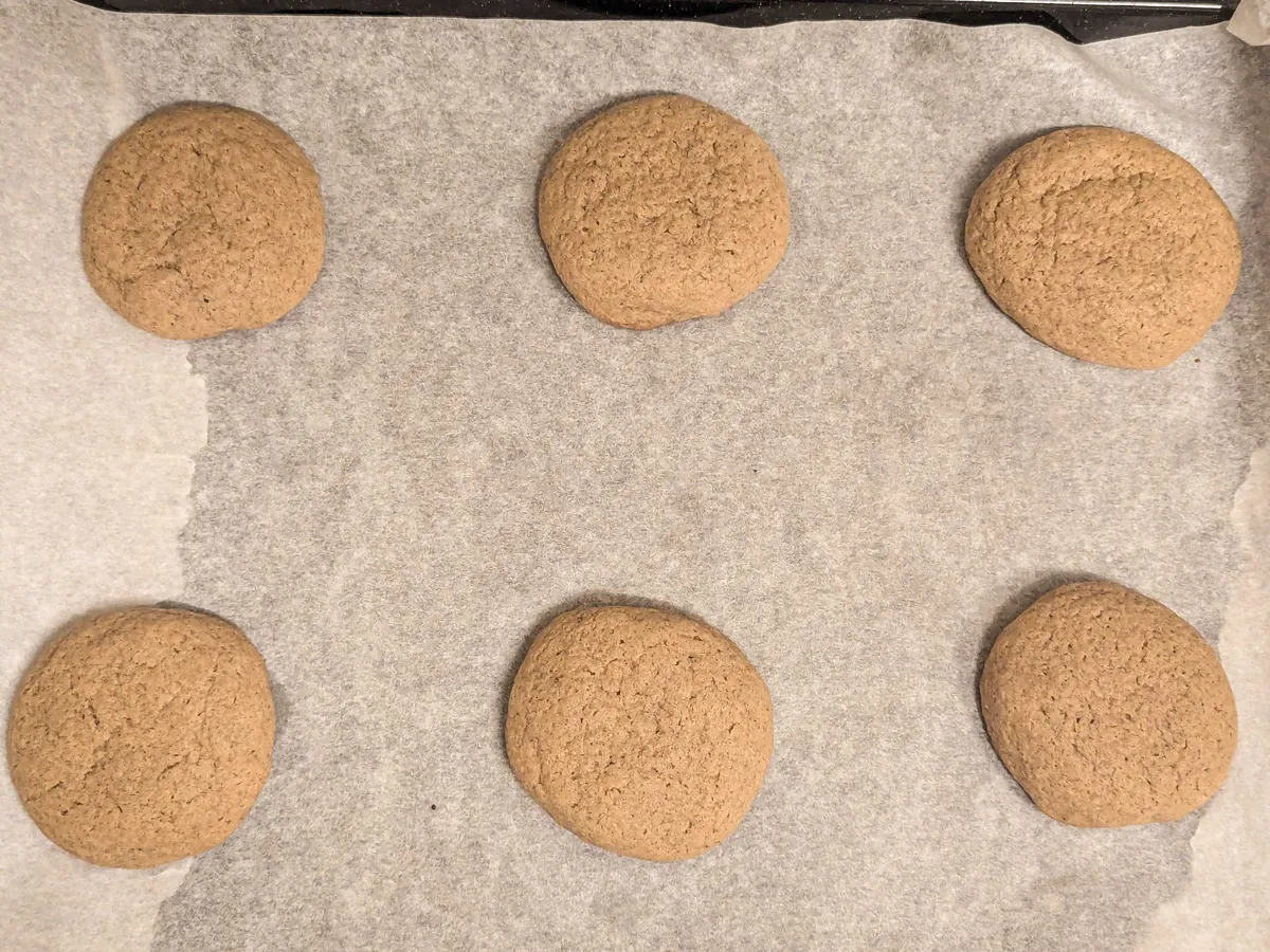 6 light brown cookies that have a smooth surface.