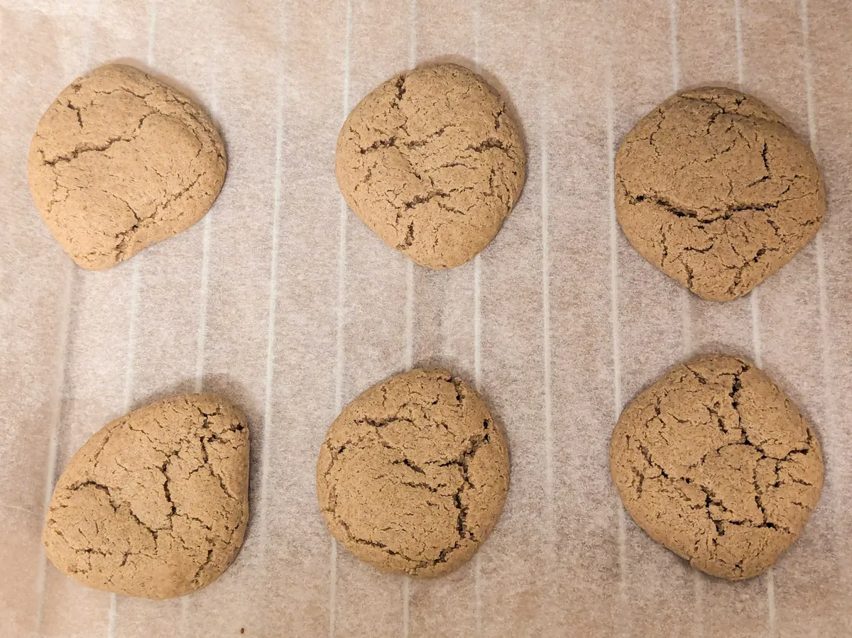 6 light brown cookies that have cracks on the surface.