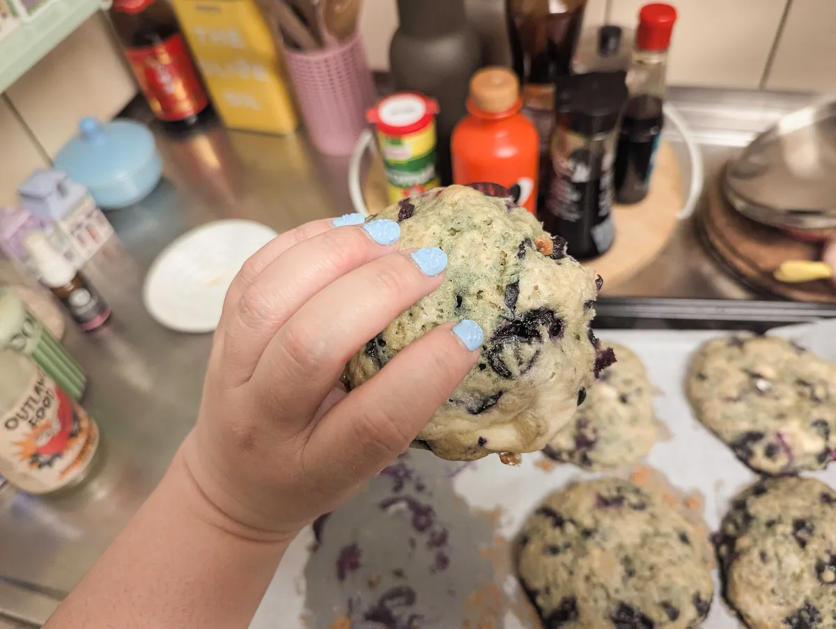 Peige holding the blueberry cookie.