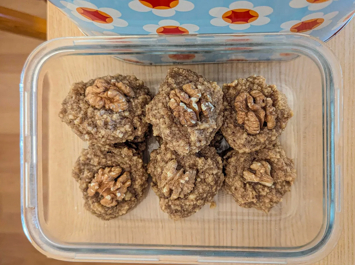Walnut cookies inside of a clear glass container.