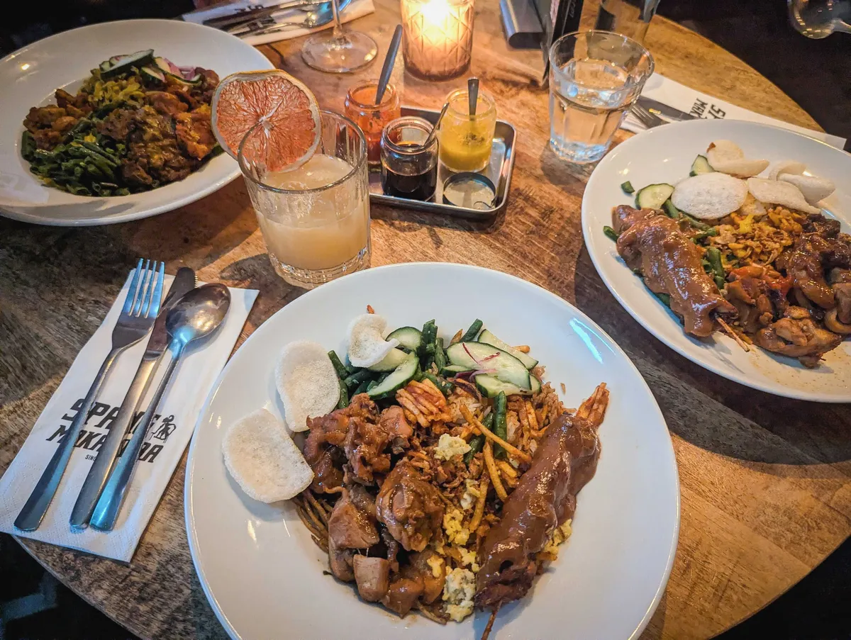 Three plates of Surinamese cuisine.
