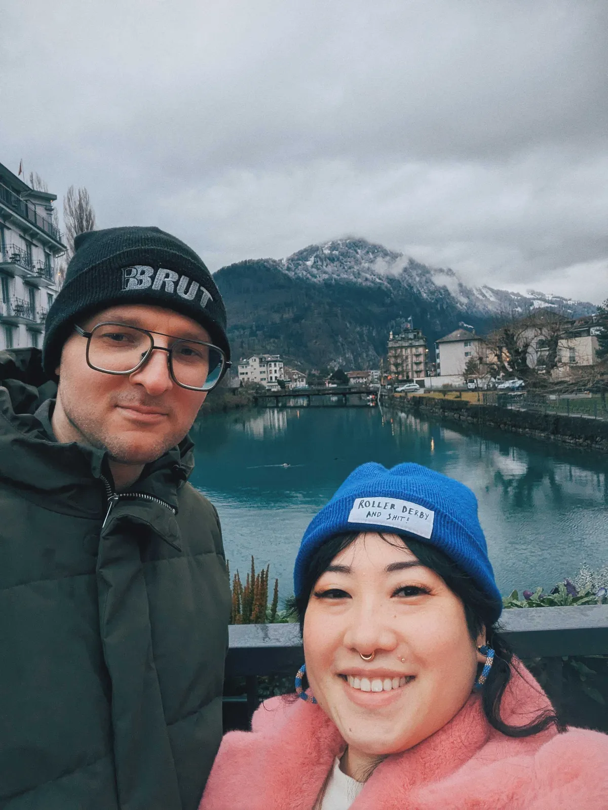 Daniel and Peige smiling with the river and mountains behind them.
