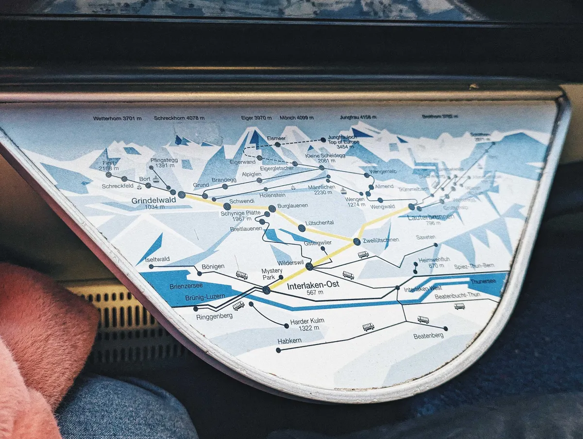 A train table with a map of the region printed on it. A yellow line highlights this train's route.