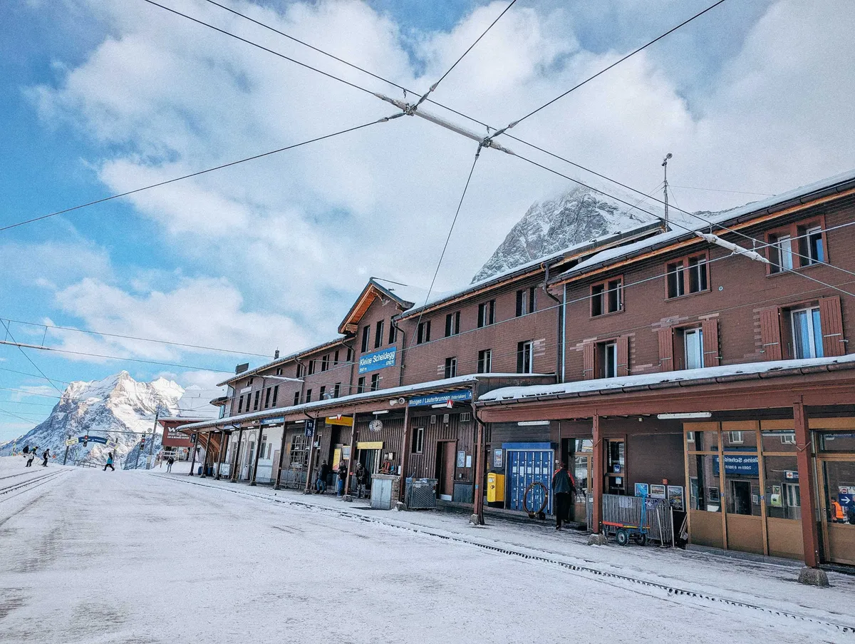 A view of the entire train station, which is a long, brown brick building.