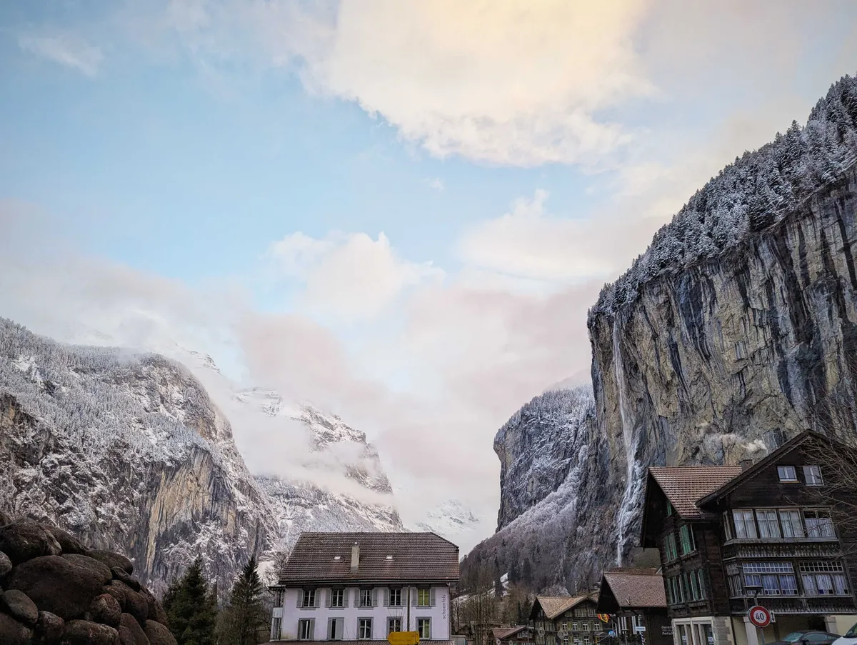 Some houses sitting beneath the mammoth Bernese mountains.