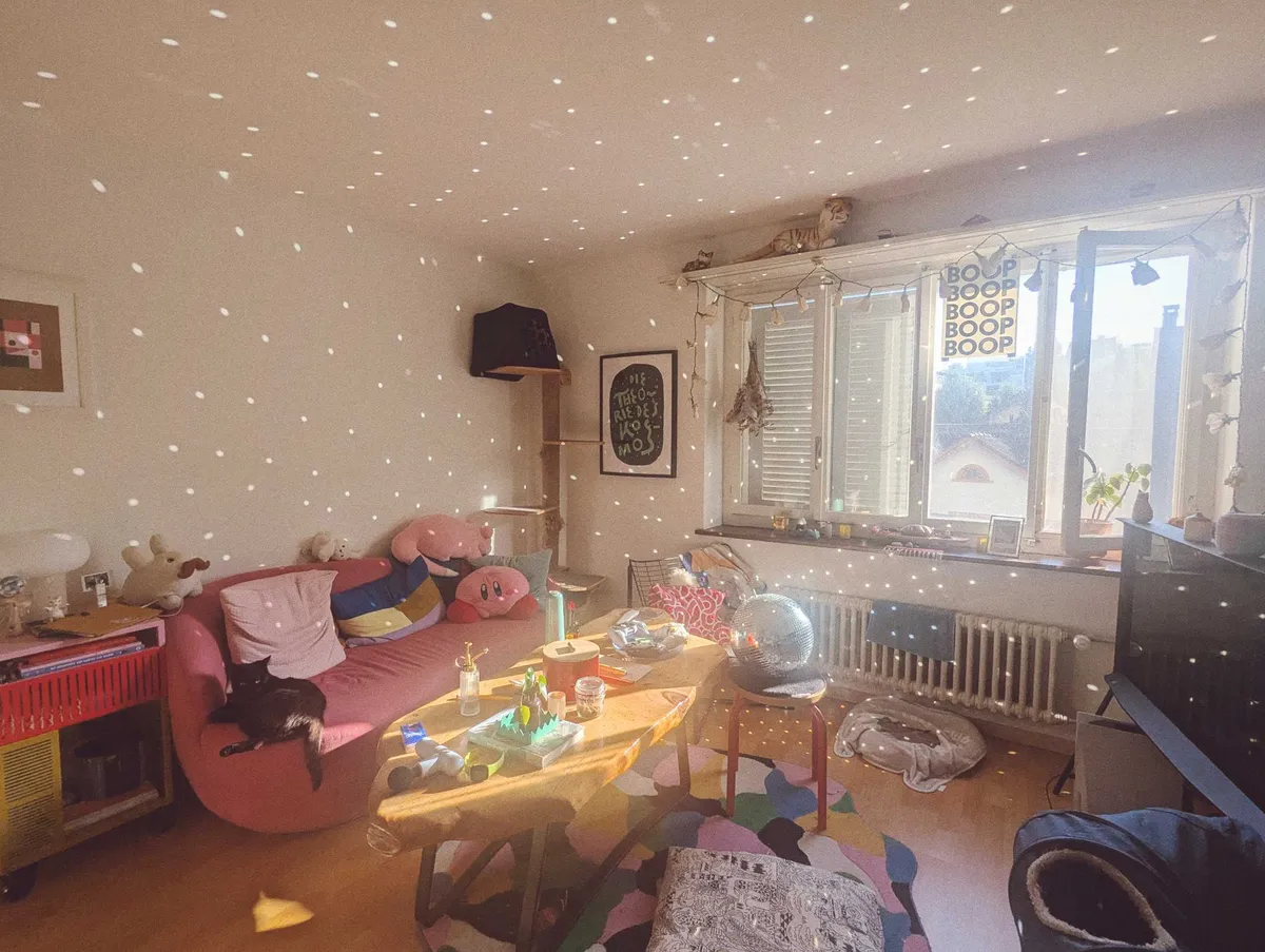 Peige's warm living room sparkling with white dots as the sunlight hits the disco ball in the center of the room.