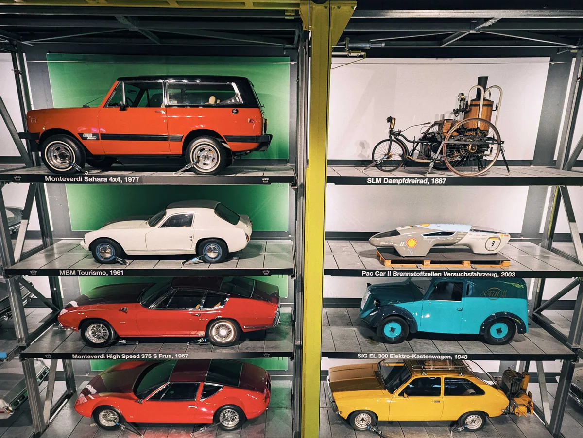 An array of cars from varying eras are displayed in a grid consisting of two columns and 4 rows, with 8 cars total.