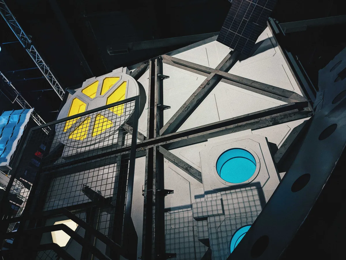 A large, futuristic-looking cube towers towards the ceiling. The windows are lit in yellow and blue.