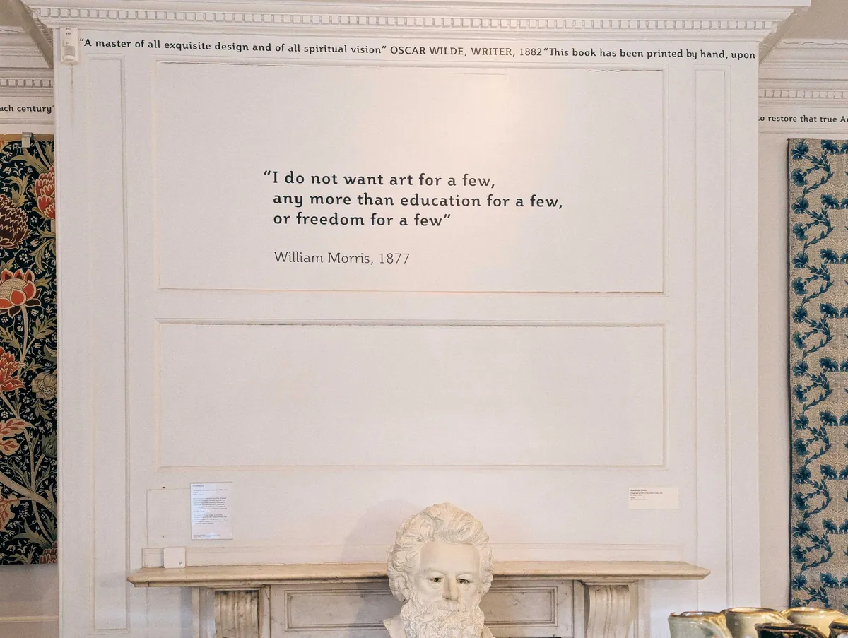 A quote printed above the fireplace that reads, "I do not want art for a few, anymore more than education for a few, or freedom for a few. William Morris, 1877."