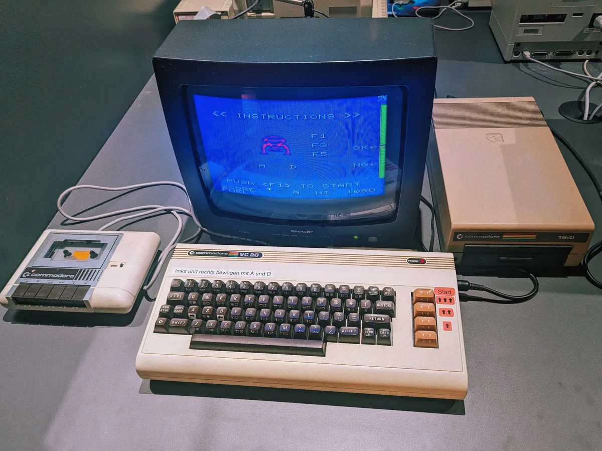 A Commodore PC setup with a spaceship landing game.