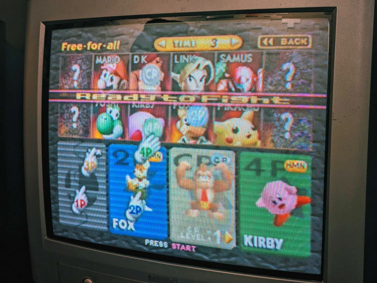 An old CRT tv with the character selection screen of from "Smash Bros. 64" displayed.