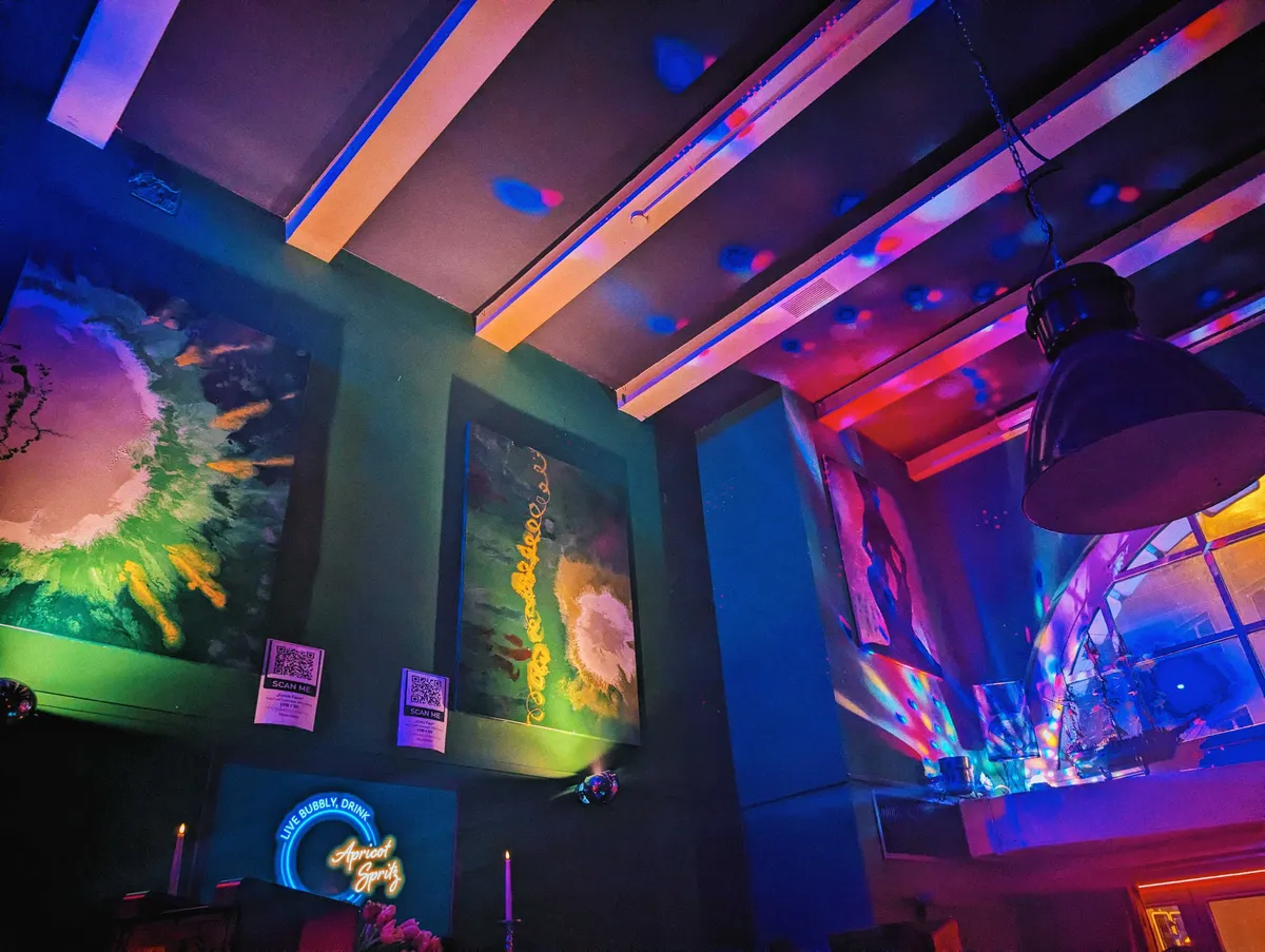 Psychedelic colors light up the ceiling of the venue.